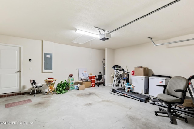 garage featuring a garage door opener, electric panel, and refrigerator