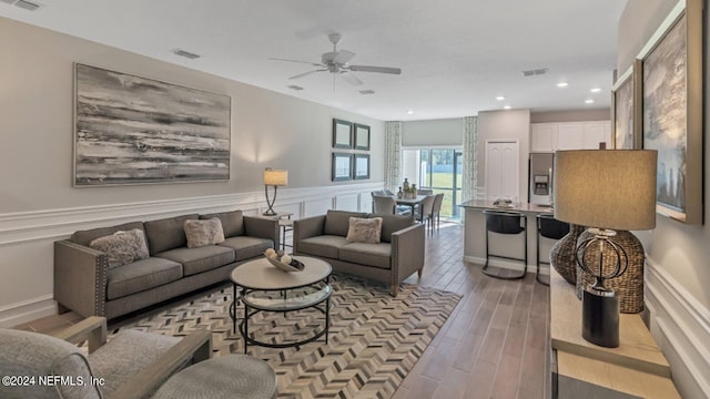 living room with visible vents, wainscoting, wood finished floors, recessed lighting, and a ceiling fan