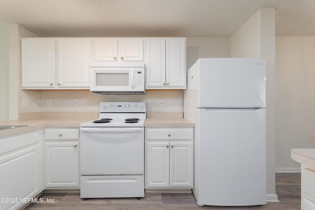 2005 Mariposa Vista Ln Unit 3-123, Saint Augustine, FL 32084 - kitchen with white cabinets, light wood finished floors, white appliances, and a textured ceiling