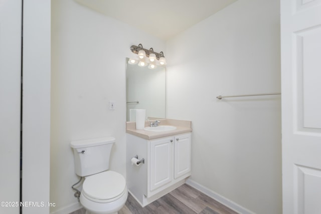 2005 Mariposa Vista Ln Unit 3-123, Saint Augustine, FL 32084 - bathroom with baseboards, wood finished floors, toilet, and vanity