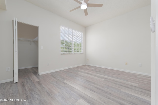2005 Mariposa Vista Ln Unit 3-123, Saint Augustine, FL 32084 - unfurnished bedroom featuring baseboards, a closet, light wood finished floors, and a spacious closet