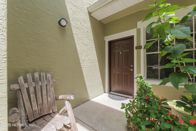 2005 Mariposa Vista Ln Unit 3-123, Saint Augustine, FL 32084 - doorway to property with stucco siding