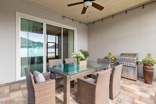 view of patio / terrace with ceiling fan, exterior kitchen, outdoor dining space, and area for grilling