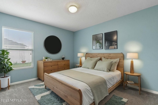 carpeted bedroom featuring a textured ceiling and baseboards