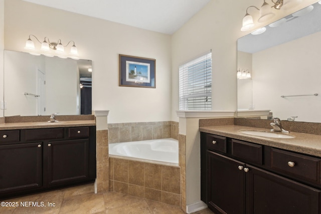 bathroom with a sink, tile patterned flooring, a garden tub, and two vanities