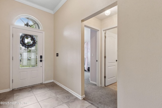 entryway featuring crown molding, baseboards, and light tile patterned floors