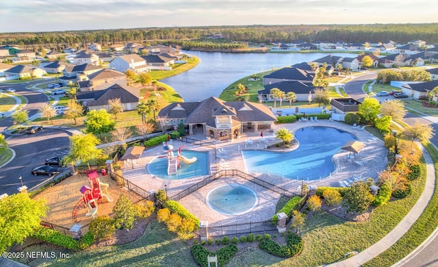 bird's eye view with a water view and a residential view