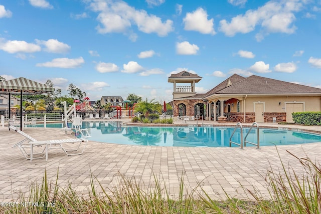 pool with fence and a patio area