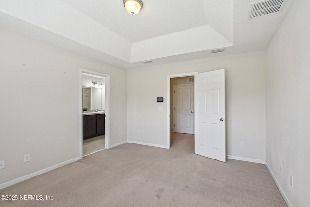 53 Nelson Ln, Saint Johns, FL 32259 - unfurnished bedroom featuring light colored carpet, visible vents, baseboards, and a raised ceiling