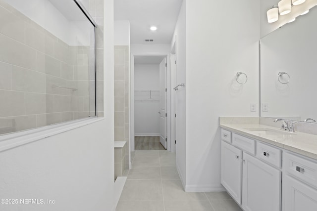 2413 Glade Ln, Green Cove Springs, FL 32043 - full bathroom featuring tiled shower, a spacious closet, vanity, and tile patterned floors