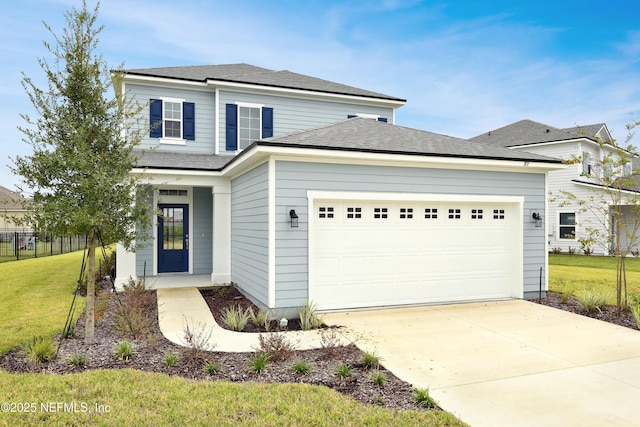 traditional home featuring fence, a shingled roof, a front lawn, a garage, and driveway