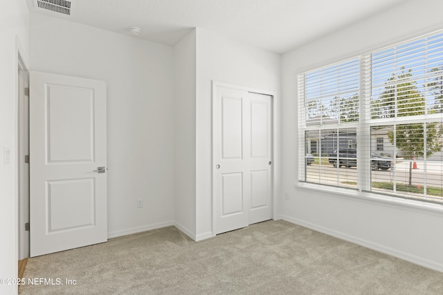 2416 Glade Ln, Green Cove Springs, FL 32043 - unfurnished bedroom featuring light carpet, baseboards, and a closet
