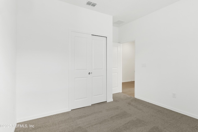 2416 Glade Ln, Green Cove Springs, FL 32043 - unfurnished bedroom featuring carpet flooring, a closet, and baseboards