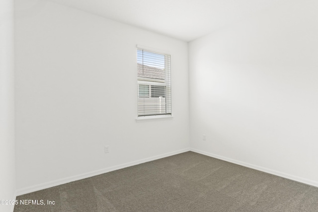 2416 Glade Ln, Green Cove Springs, FL 32043 - empty room with dark colored carpet and baseboards