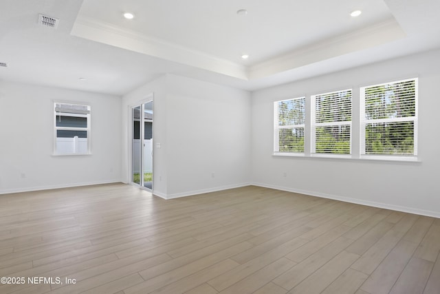2416 Glade Ln, Green Cove Springs, FL 32043 - spare room featuring a tray ceiling, crown molding, light wood-style floors, baseboards, and recessed lighting