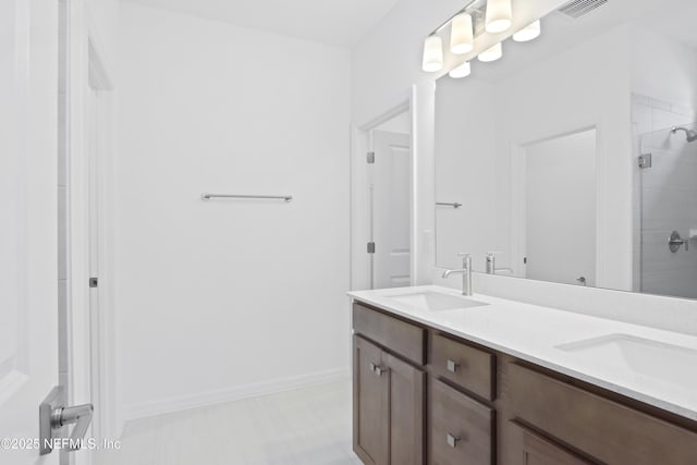 2416 Glade Ln, Green Cove Springs, FL 32043 - full bathroom featuring double vanity, a tile shower, and baseboards