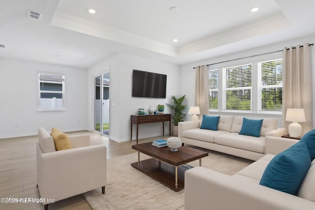 2416 Glade Ln, Green Cove Springs, FL 32043 - living room featuring a tray ceiling, light wood-style flooring, recessed lighting, ornamental molding, and baseboards