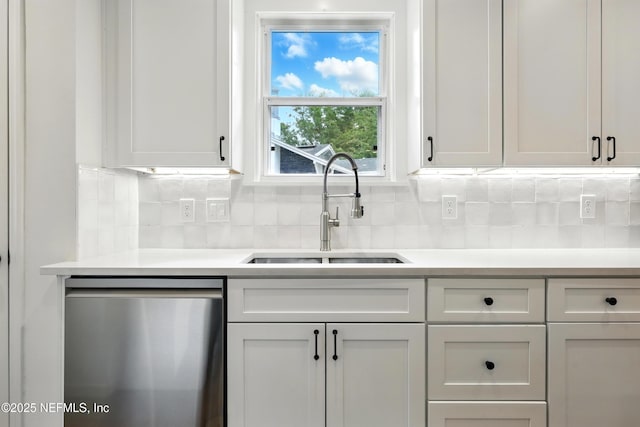 kitchen featuring a sink, decorative backsplash, dishwasher, and light countertops