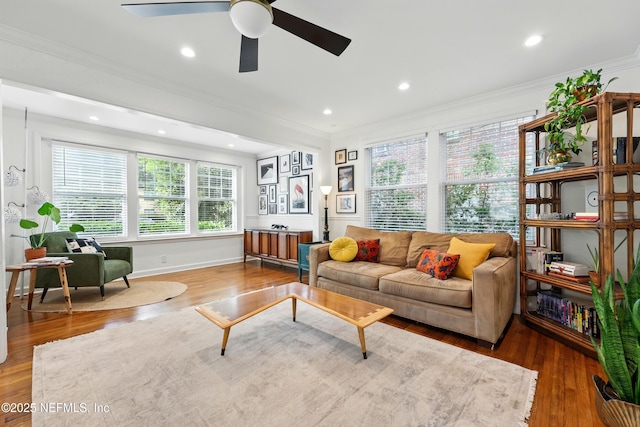 living area with ceiling fan, wood finished floors, baseboards, ornamental molding, and recessed lighting