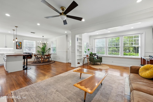 living area featuring recessed lighting, ornamental molding, and wood finished floors