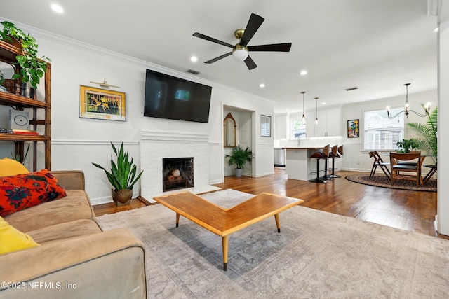 living room with baseboards, recessed lighting, and wood finished floors