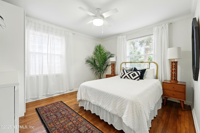 bedroom featuring crown molding, a ceiling fan, and wood finished floors