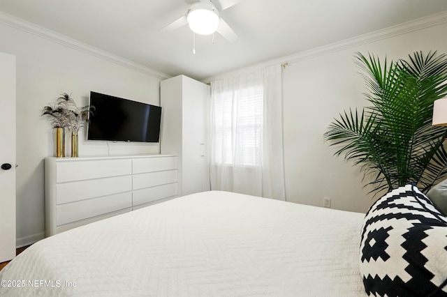bedroom with ornamental molding and ceiling fan