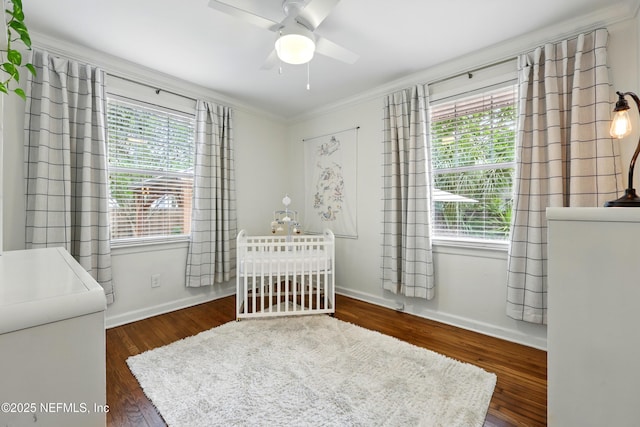 bedroom featuring crown molding, multiple windows, and wood finished floors