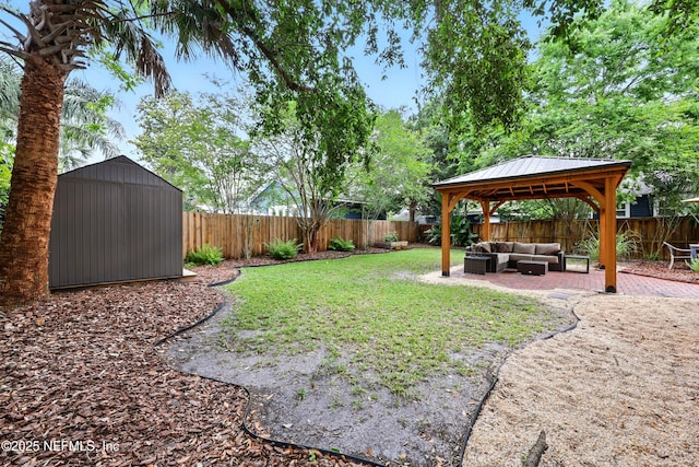 view of yard with a storage shed, a gazebo, a fenced backyard, a patio, and outdoor lounge area
