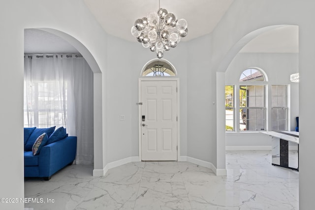 132 Summerhill Cir, Saint Augustine, FL 32086 - entrance foyer featuring arched walkways, a chandelier, and marble finish flooring