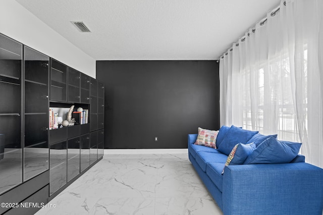 132 Summerhill Cir, Saint Augustine, FL 32086 - living area with light marble finish flooring and a textured ceiling