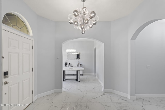 132 Summerhill Cir, Saint Augustine, FL 32086 - foyer featuring a chandelier, marble finish floors, and arched walkways