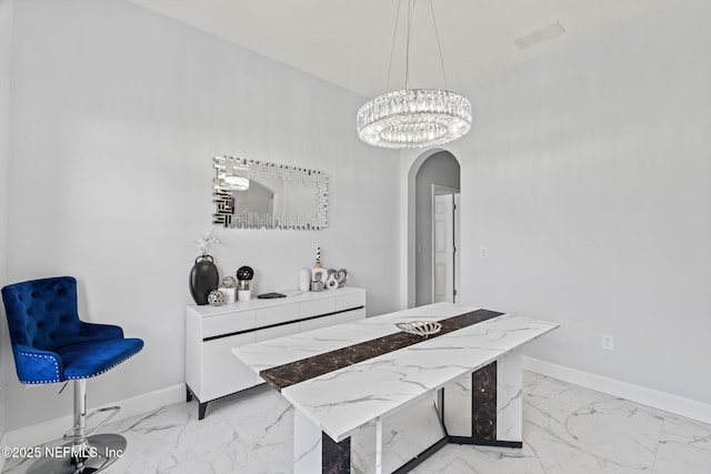 132 Summerhill Cir, Saint Augustine, FL 32086 - dining space featuring arched walkways, light marble finish flooring, and a chandelier