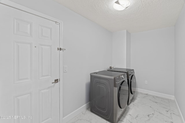 132 Summerhill Cir, Saint Augustine, FL 32086 - washroom with washer and clothes dryer, light marble finish flooring, and a textured ceiling