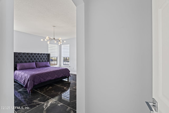 132 Summerhill Cir, Saint Augustine, FL 32086 - bedroom featuring marble tiled flooring, a chandelier, and a textured ceiling