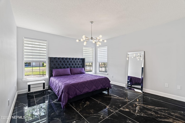 132 Summerhill Cir, Saint Augustine, FL 32086 - bedroom with a chandelier, marble tiled floors, and a textured ceiling