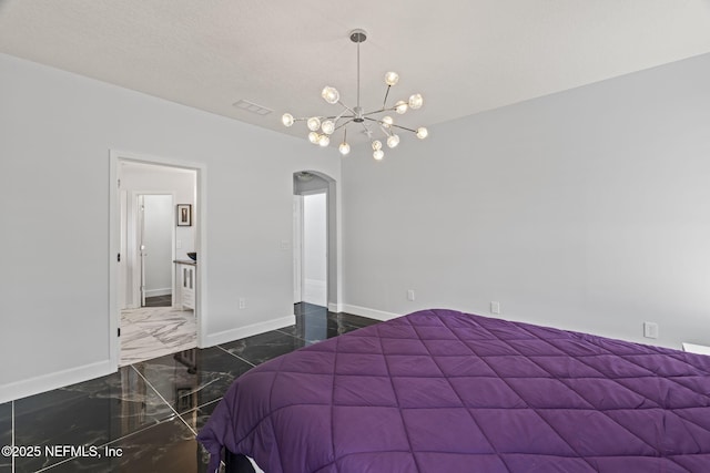 132 Summerhill Cir, Saint Augustine, FL 32086 - bedroom with arched walkways, marble tiled flooring, and a chandelier