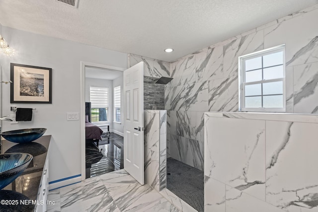 132 Summerhill Cir, Saint Augustine, FL 32086 - ensuite bathroom featuring a marble finish shower, marble tiled flooring, double vanity, a textured ceiling, and recessed lighting