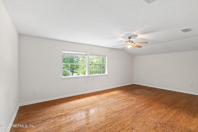 132 Summerhill Cir, Saint Augustine, FL 32086 - spare room featuring a textured ceiling, ceiling fan, light wood finished floors, and vaulted ceiling