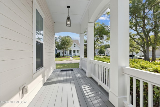 1553 Coastal Oaks Cir, Fernandina Beach, FL 32034 - wooden terrace with covered porch