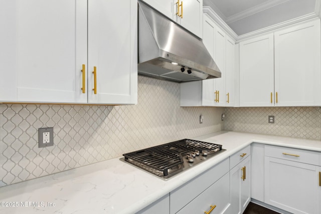 1553 Coastal Oaks Cir, Fernandina Beach, FL 32034 - kitchen featuring crown molding, white cabinets, decorative backsplash, stainless steel gas stovetop, and under cabinet range hood