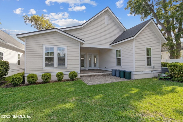 1553 Coastal Oaks Cir, Fernandina Beach, FL 32034 - back of property featuring french doors and a lawn