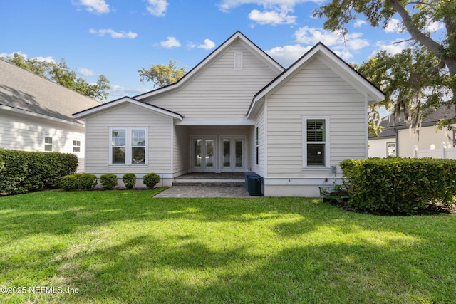 1553 Coastal Oaks Cir, Fernandina Beach, FL 32034 - back of house with a lawn and french doors