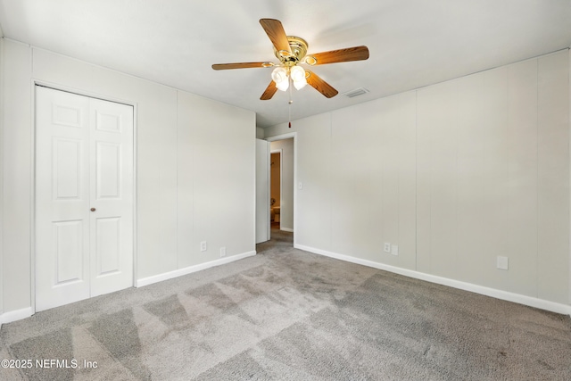 unfurnished bedroom with carpet floors, a ceiling fan, baseboards, and visible vents