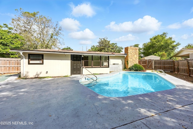view of pool with a fenced in pool, a fenced backyard, and a patio area