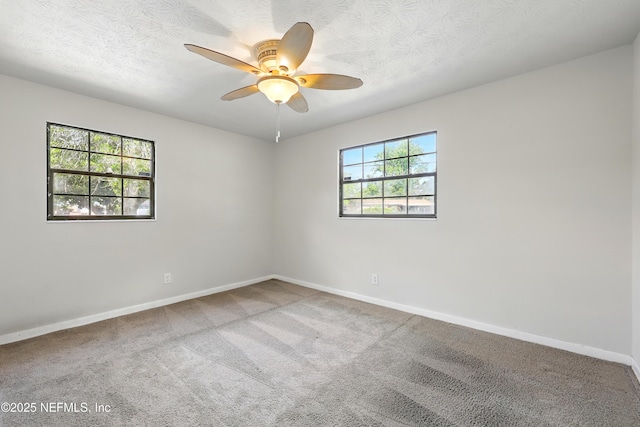 unfurnished room featuring baseboards, ceiling fan, carpet flooring, and a textured ceiling