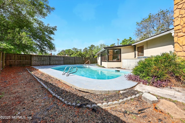 view of swimming pool with a fenced in pool and a fenced backyard