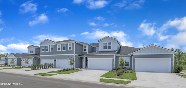 view of property with concrete driveway, an attached garage, board and batten siding, and a residential view