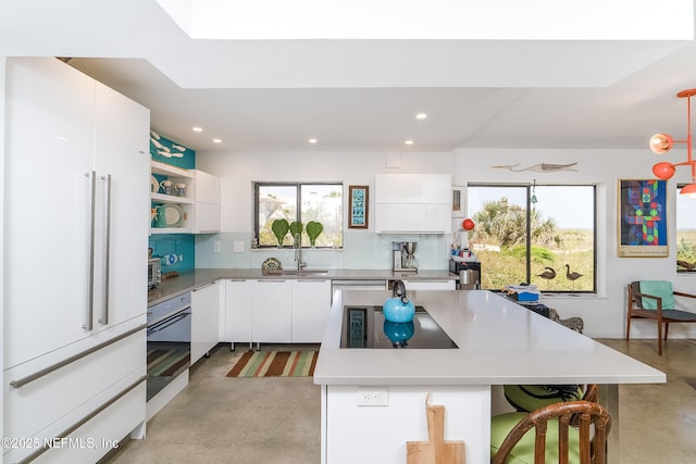 2900 Coastal Hwy # 1, Saint Augustine, FL 32084 - kitchen featuring white appliances, concrete flooring, open shelves, and white cabinetry