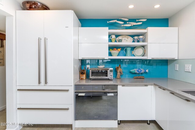 2900 Coastal Hwy # 1, Saint Augustine, FL 32084 - kitchen featuring white cabinets, high end white fridge, light countertops, a toaster, and modern cabinets